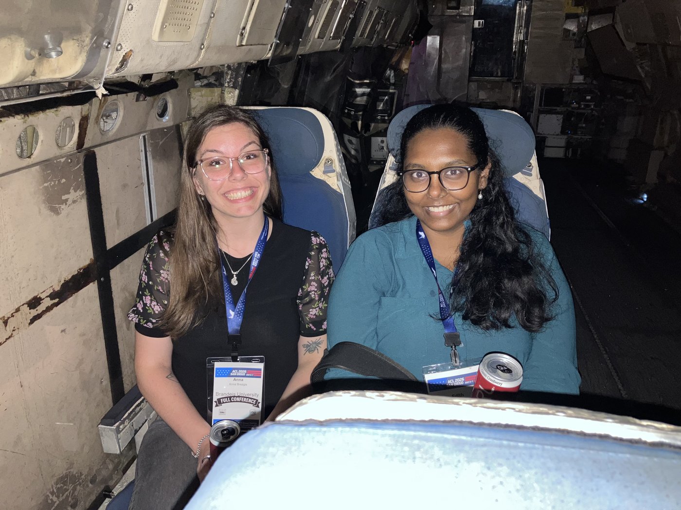 Two friends buckled into aircraft ejection seats aboard the USS Midway.
