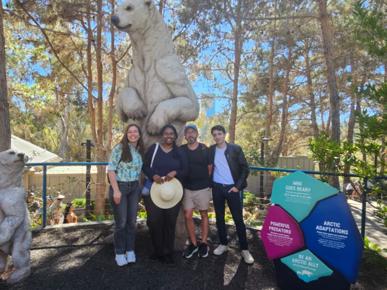 The group posing beneath a giant polar bear statue at the zoo's Arctic exhibit.