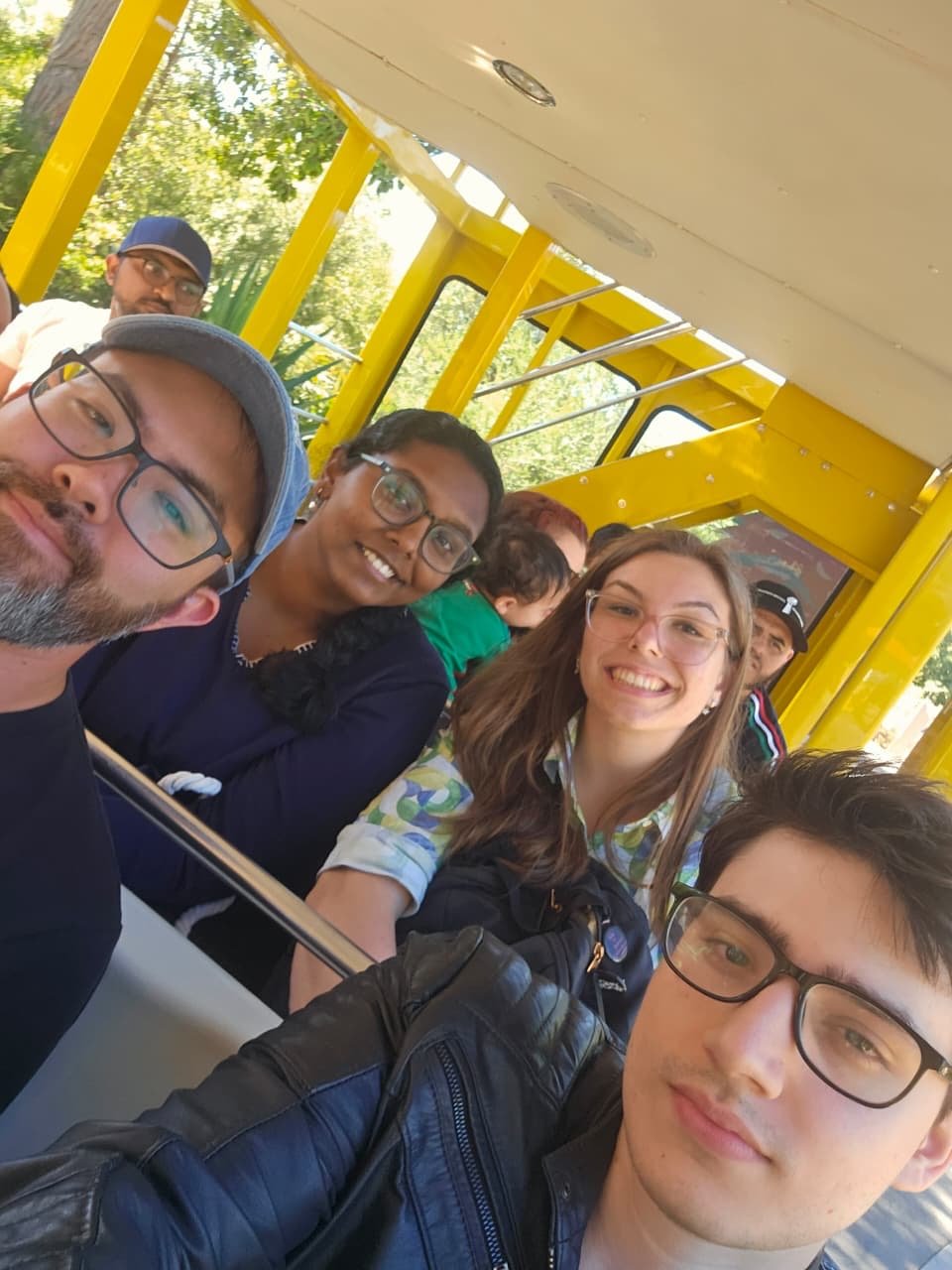 A group selfie aboard the zoo's yellow guided-tour tram.