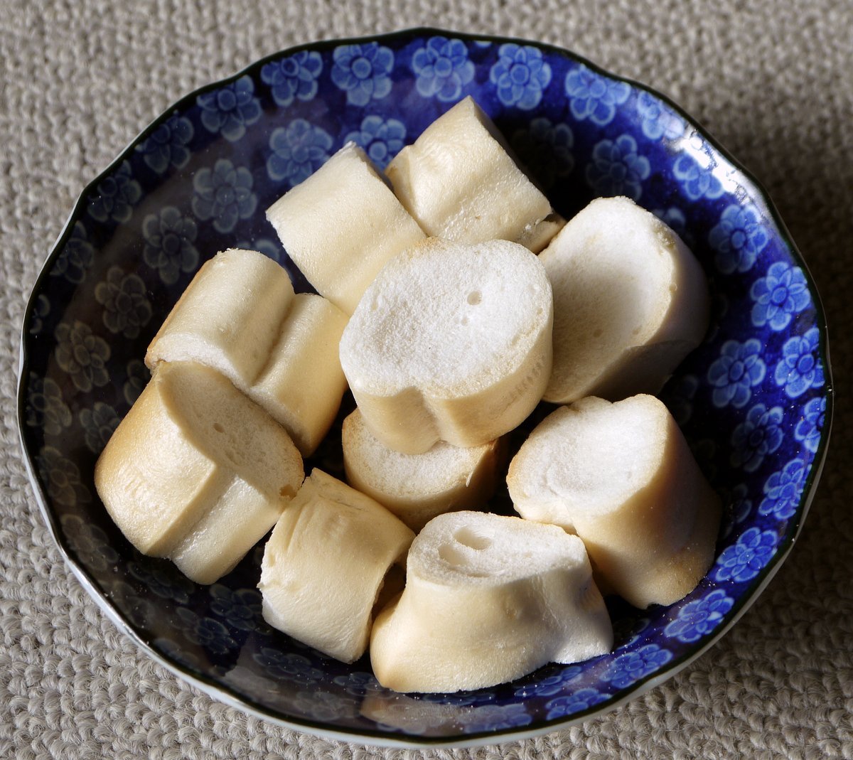 Pieces of dried fu, Japanese wheat gluten, in a blue-and-white flowered bowl. Via Wikimedia Commons.