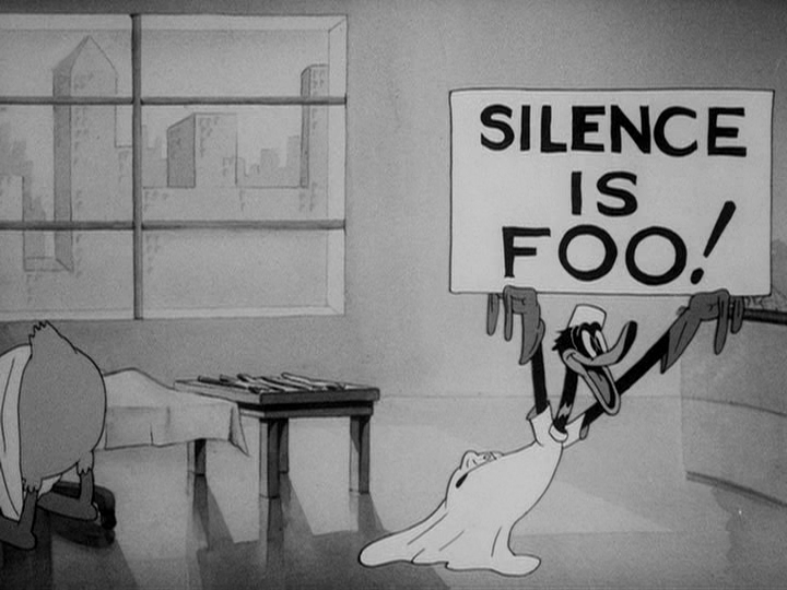 Daffy Duck holds up the 'SILENCE IS FOO!' sign in The Daffy Doc (Warner Bros., 1938, dir. Bob Clampett). Frame via the Tralfaz blog.