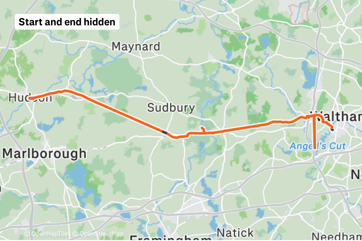 A map of eastern Massachusetts with the day's ride traced in orange: from Waltham west through Sudbury along the rail trail to Hudson, with a short spur south of Waltham. A label in the corner reads Start and end hidden.